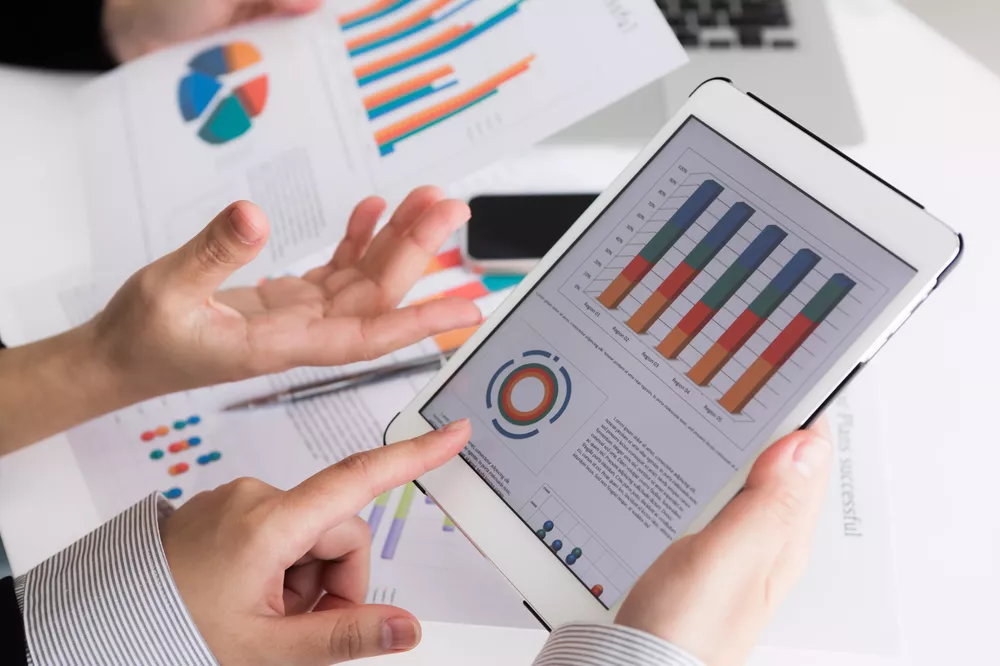 close-up-of-business-team-using-digital-tablet-with-financial-d